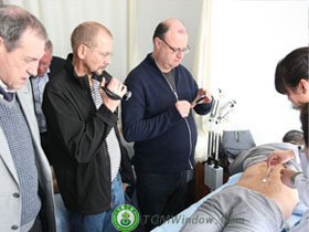 Back pain treatment is most often focused on the back. A member of the Brazilian medical delegation is receiving an acupuncture therapy for back pain.