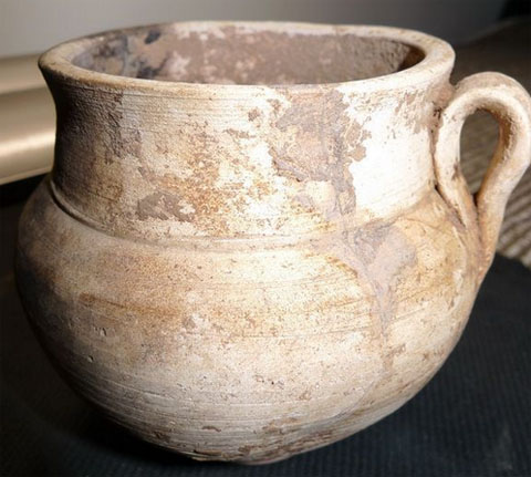 white pottery cup with single ear